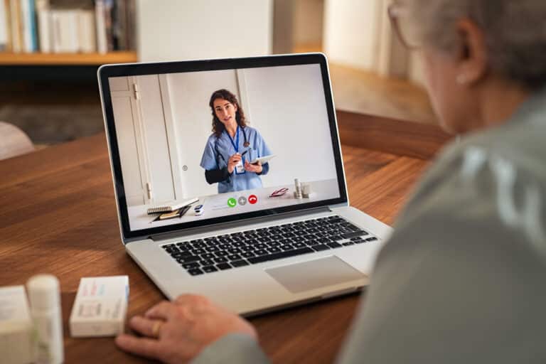 Telerehabilitation in Physical Therapy: a senior woman talks to her doctor on telehealth