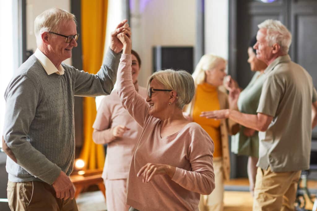 Hearing loss and brain health: seniors enjoy a dance class together at a community center