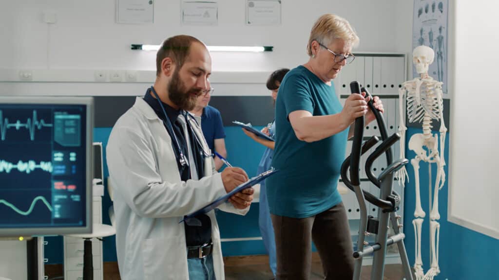 A senior patient participates in heart disease exercise training for coronary artery disease.