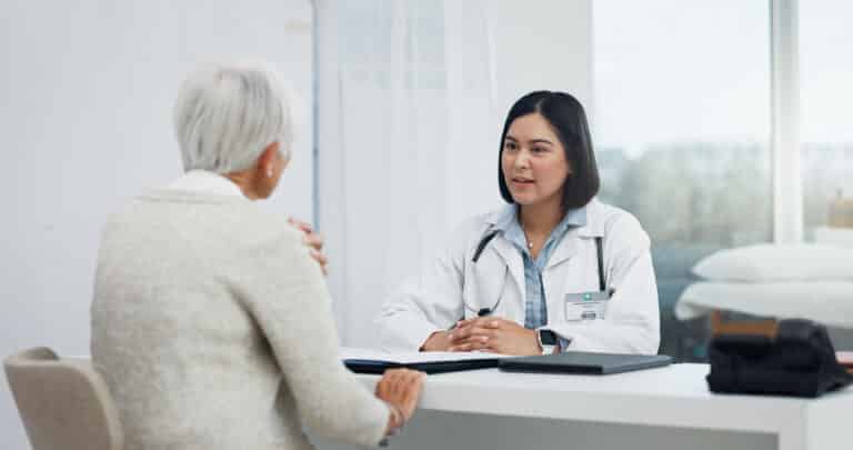 Image of a senior woman discussing arthroscopic shoulder surgery with her doctor