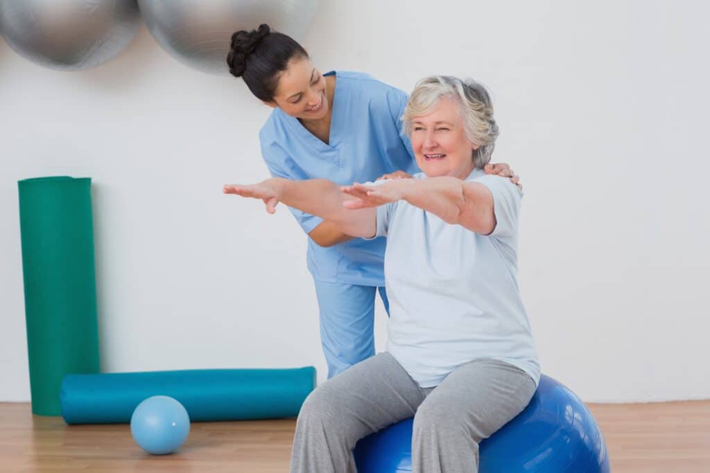Image of a senior woman doing exercises with a physical therapist for gout