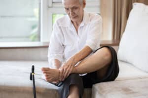Image of elderly man rubbing foot from plantar fasciitis