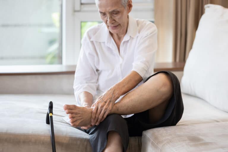 Image of elderly man rubbing foot from plantar fasciitis