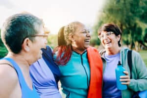 Senior women laughing together outdoors after a workout