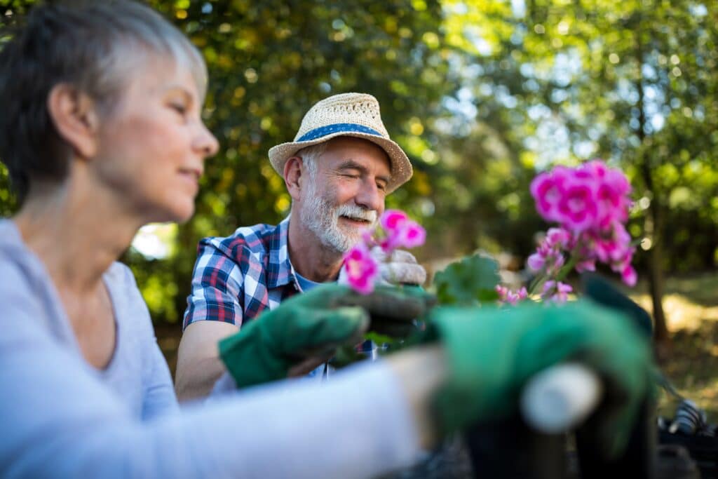 Happy seniors gardening together without hand or wrist pain.