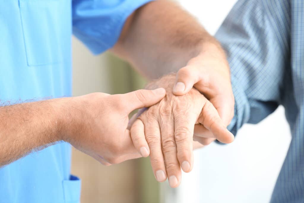 Arthritis Treatment for the Wrist & Hand: Image of a senior man using massage to manage arthritic hands, fingers, and wrists. 