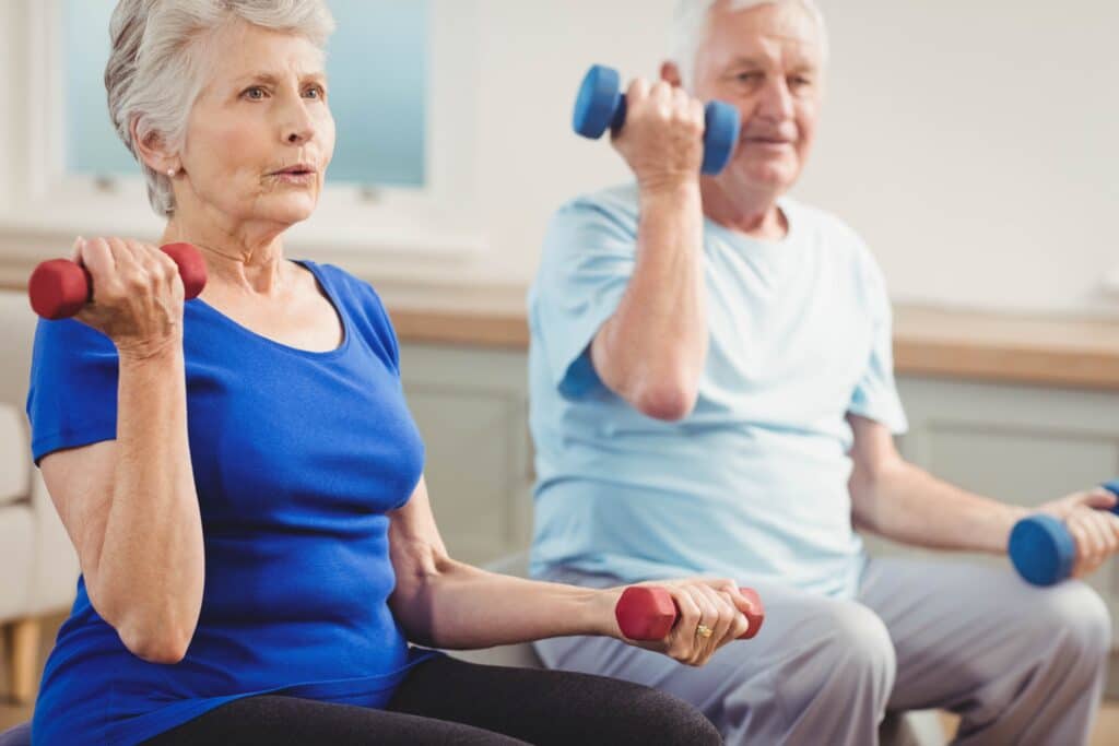 How To Tell If You Are Out of Shape & What to Do About It: Image of two seniors lifting weights in a gym workout. 