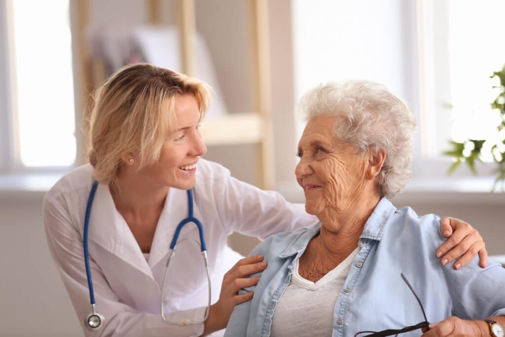 An elderly woman speaks to her friendly doctor during a check-up