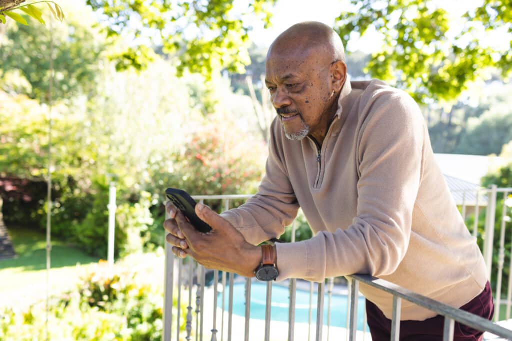 How to Use Uber and Other Rideshare Services: A Senior African American Man hails an Uber from his Smartphone