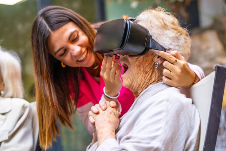 Gaming in physical Therapy & Rehabilitation: a senior woman has virtual reality headset on in a clinic