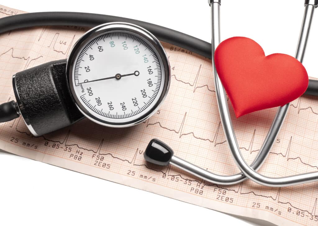 Image of a blood pressure cuff and a small stuffed heart