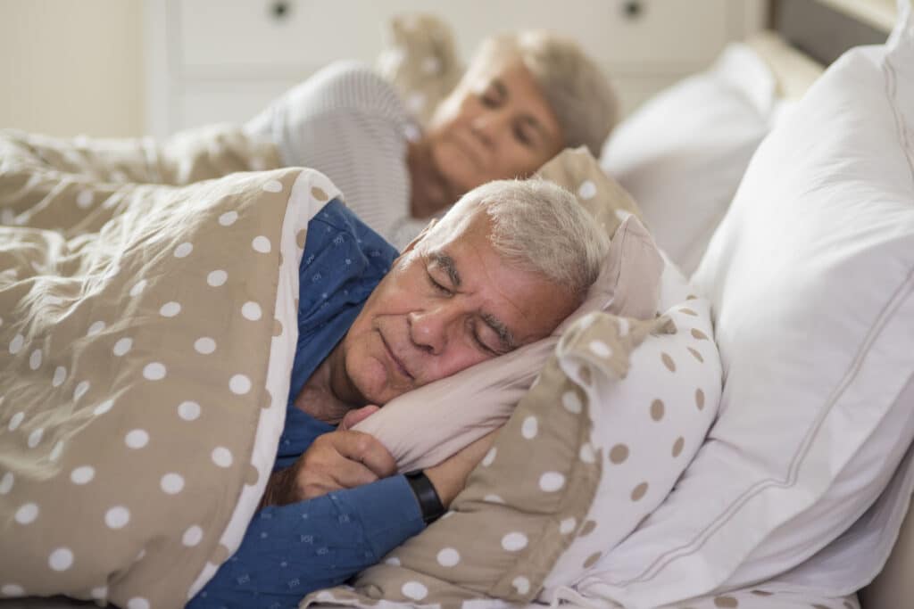 I Woke Up With Neck Pain And Can't Turn My Head: senior couple sleeping in their bed