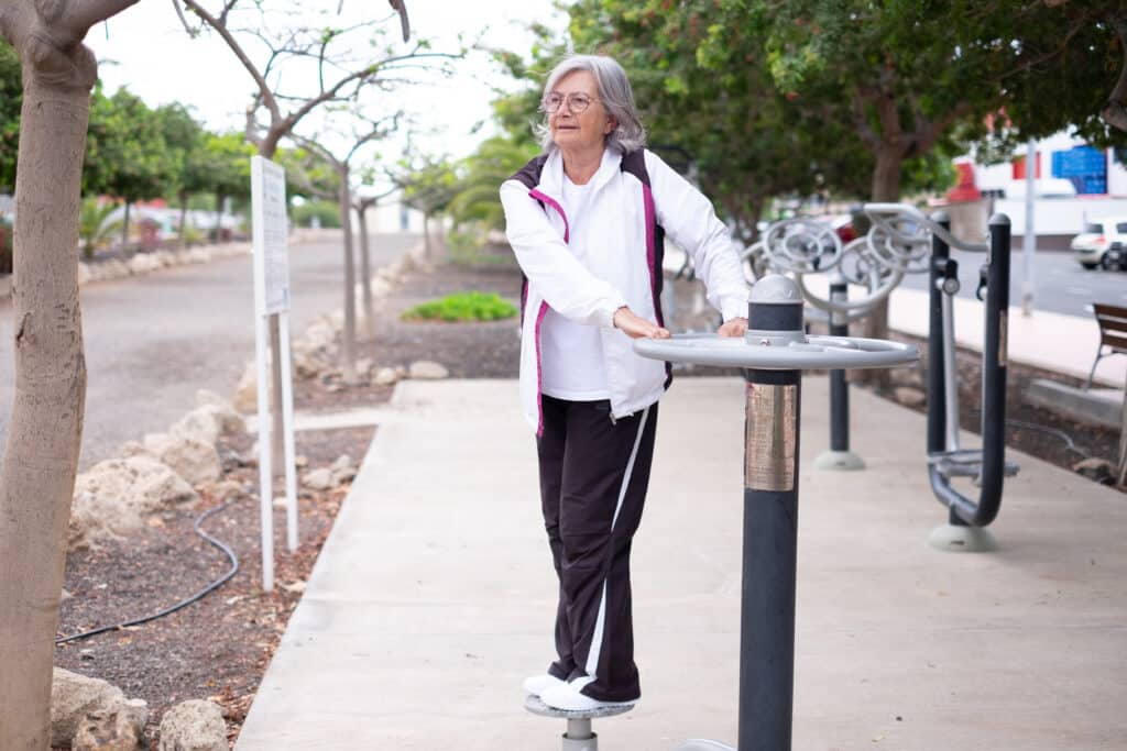 Backward disequilibrium: a senior woman practice balance outdoors