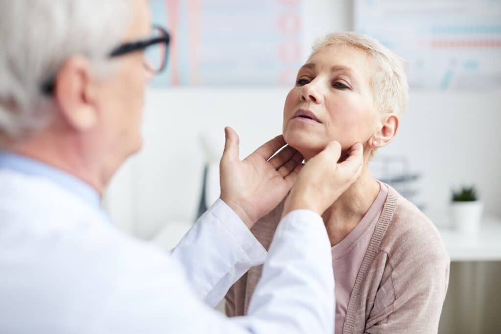 Doctor checking size of lymph nodes