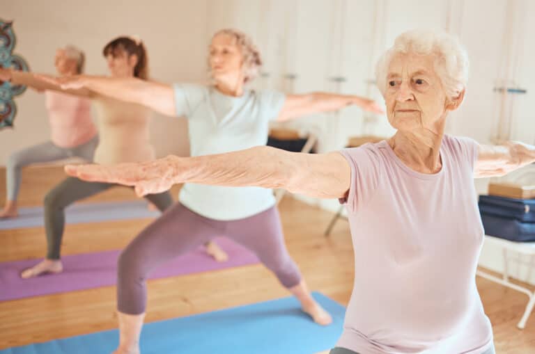 Senior women doing yoga to prevent hip flexor pain