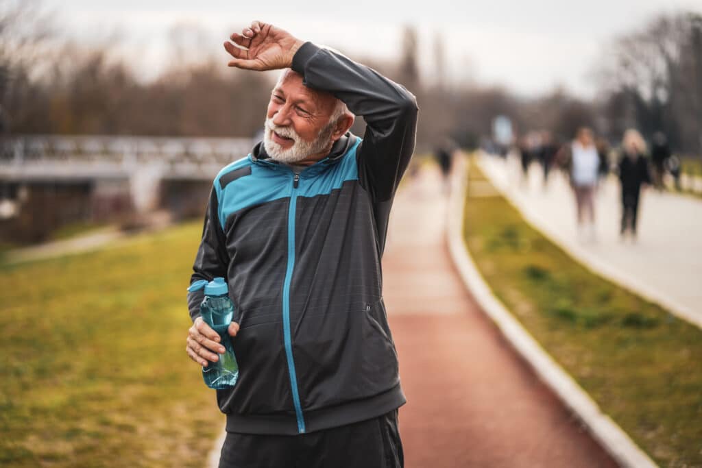 How Hard Should I Exercise?: Image of a senior man taking a break while jogging outdoors