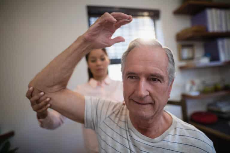 Pinched nerve in shoulder: image of a man getting a shoulder examination for pain