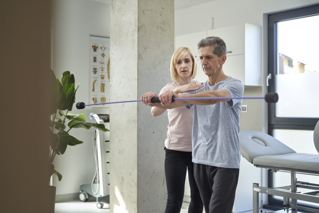 Female physical therapist working with senior man about his balance