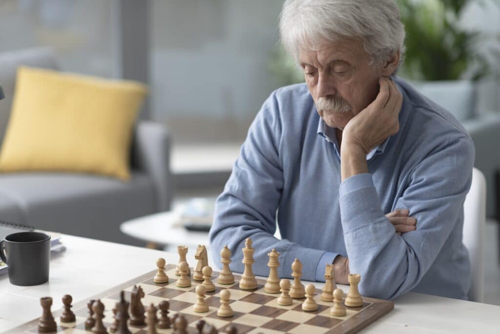 Focused senior man playing chess