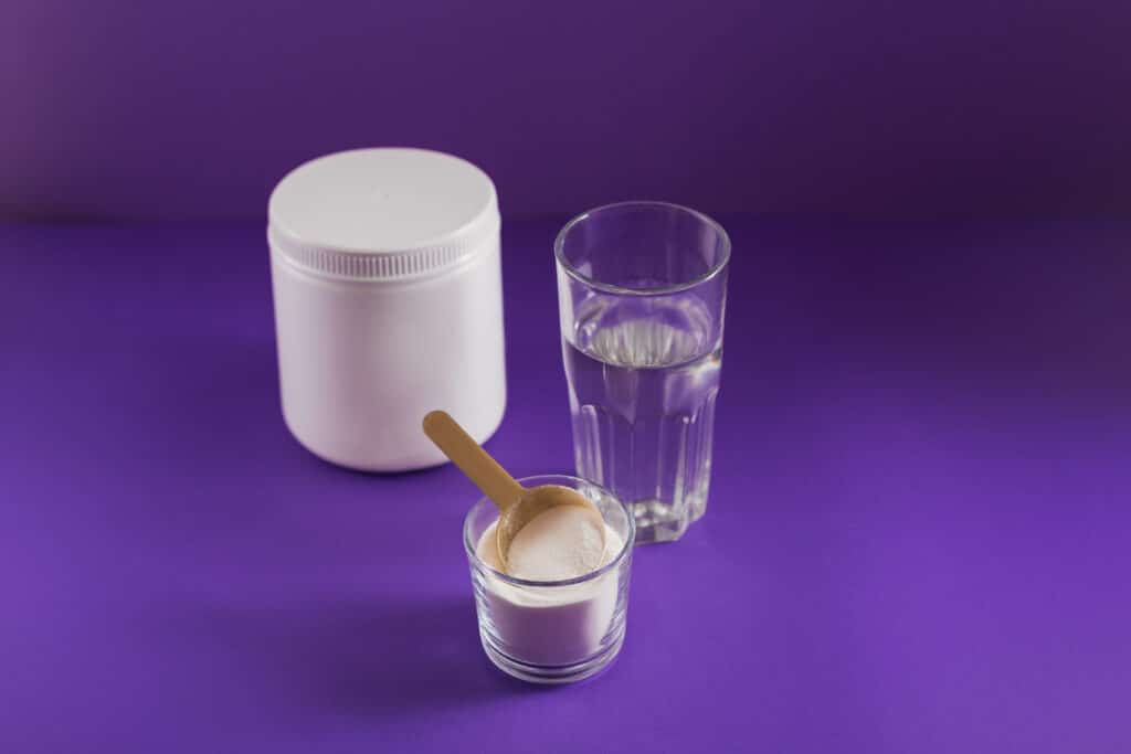 Image of a glass of water and collagen supplements for joint health