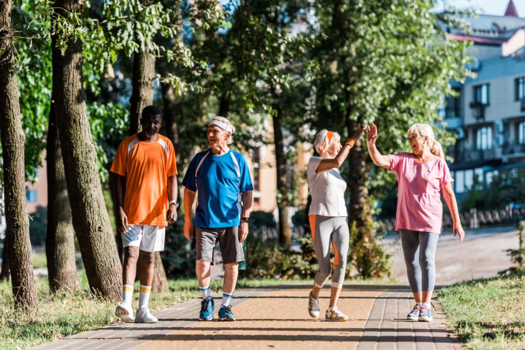 Stem cell treatment for arthritis may be a helpful treatment to keep you up and moving: image of four senior friends walking and being active outdoors