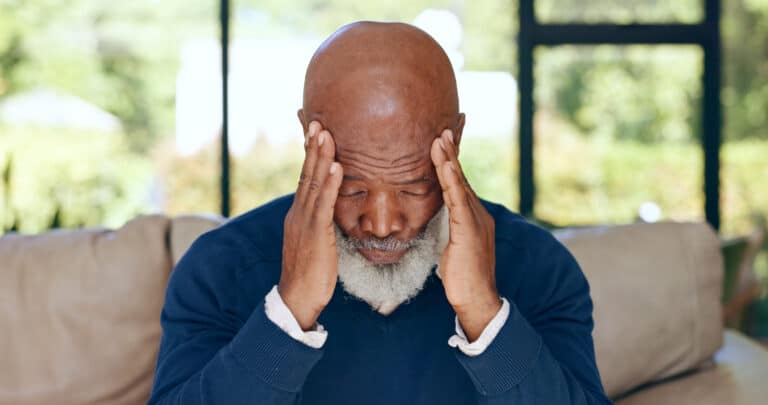 Image of an older black man rubbing his head; headaches are among many common stroke symptoms