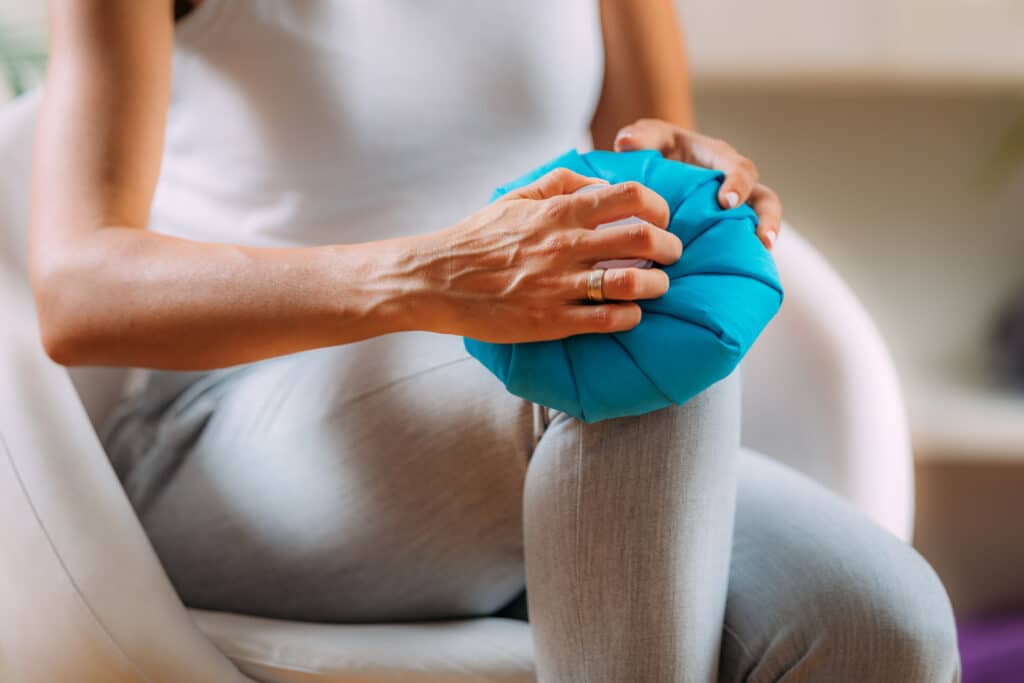 Image of a woman icing her knee