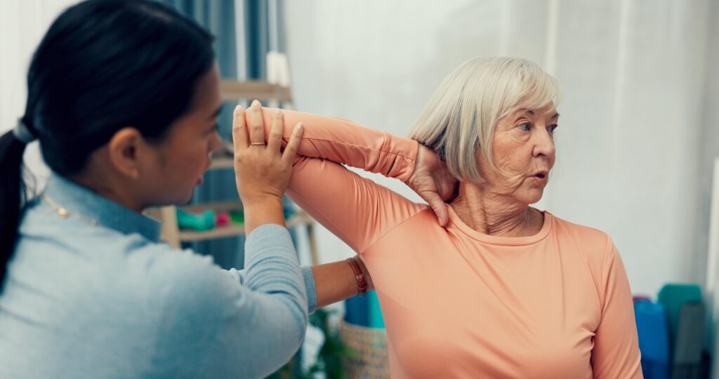 Shoulder crepitus: a senior woman is screened for shoulder pain by a doctor