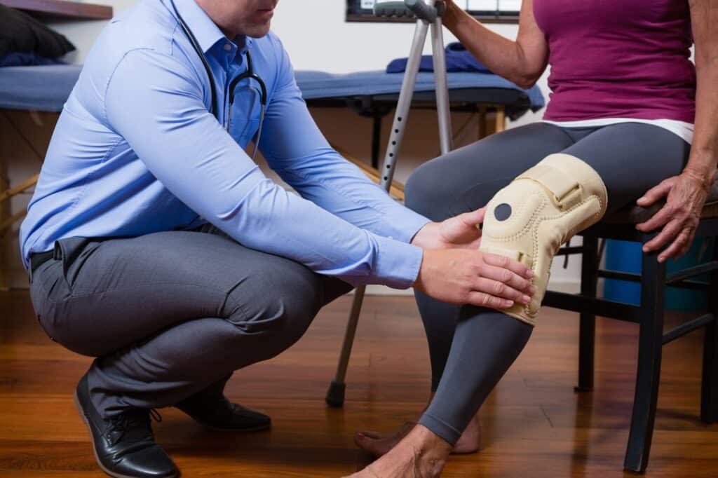 Physical therapist examining knee