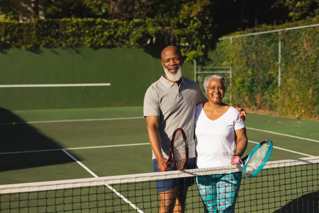 Pickleball vs Tennis: Happy senior African American couple after a tennis match