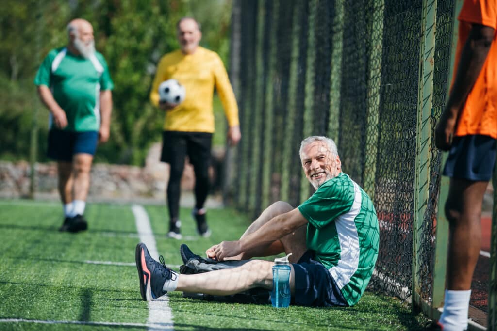 Sciatica Exercises for Seniors: an older man prepares to play soccer