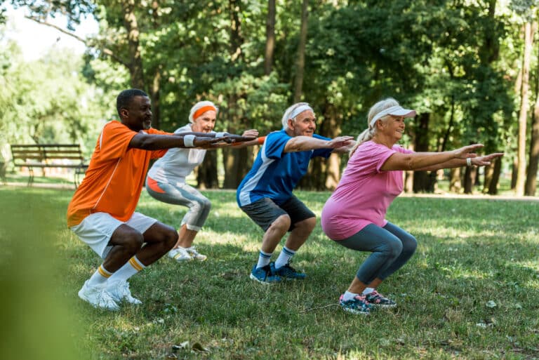 Image of seniors exercising outdoors without knee pain while squatting