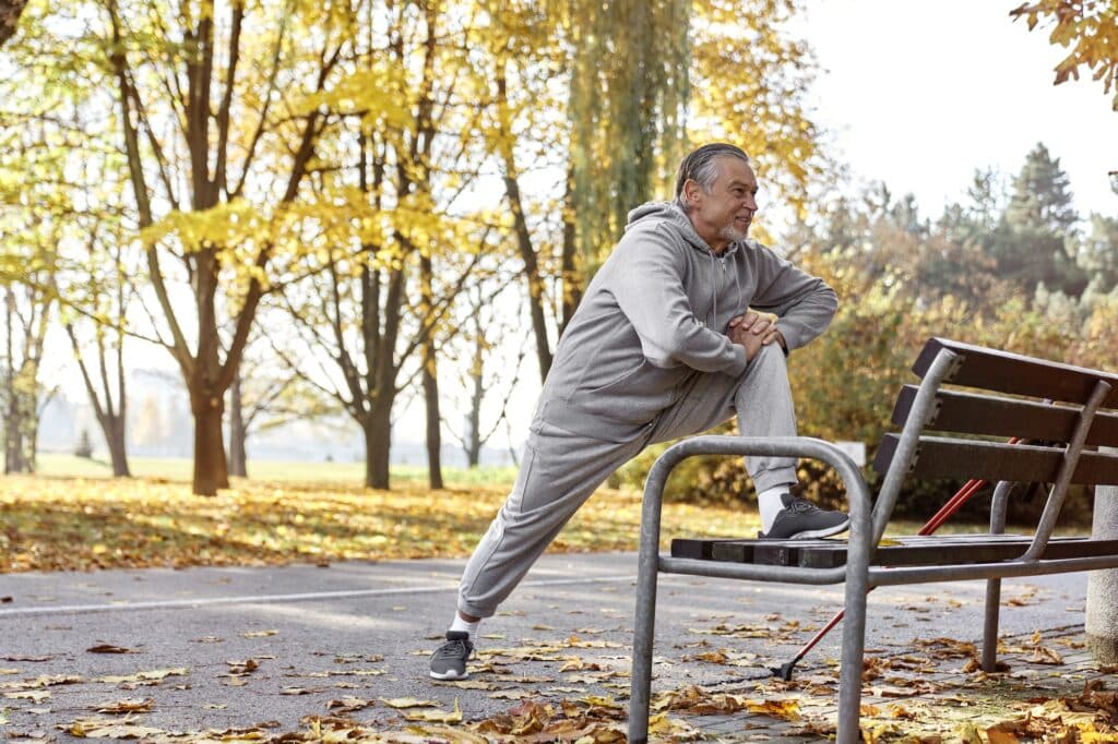 Senior caucasian man stretching in the park