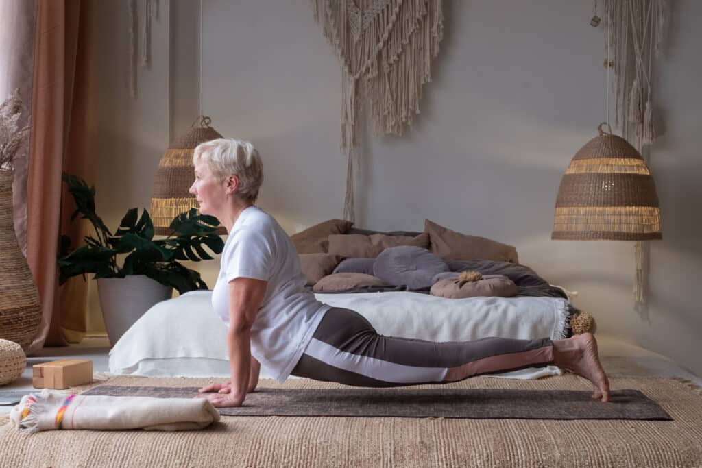 Lumbar traction: a senior woman does a back bend with a healthy spine.