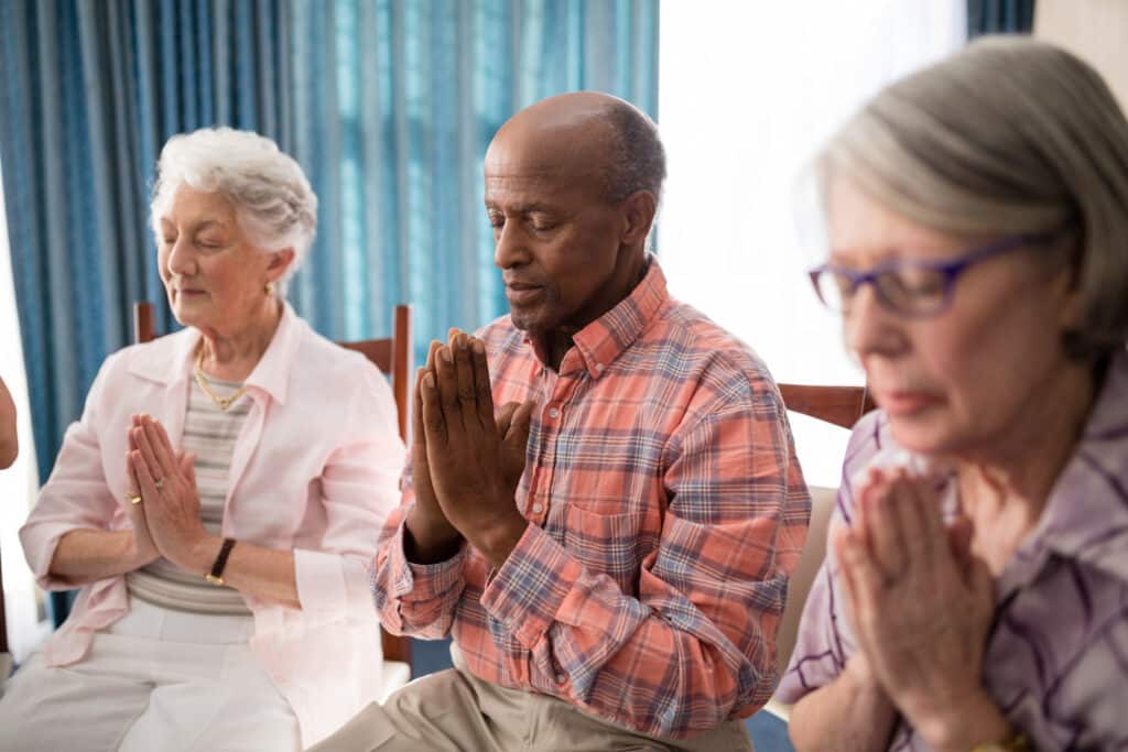 Cognitive exercise can include prayer or meditation as seen in this photo of seniors in a prayer circle