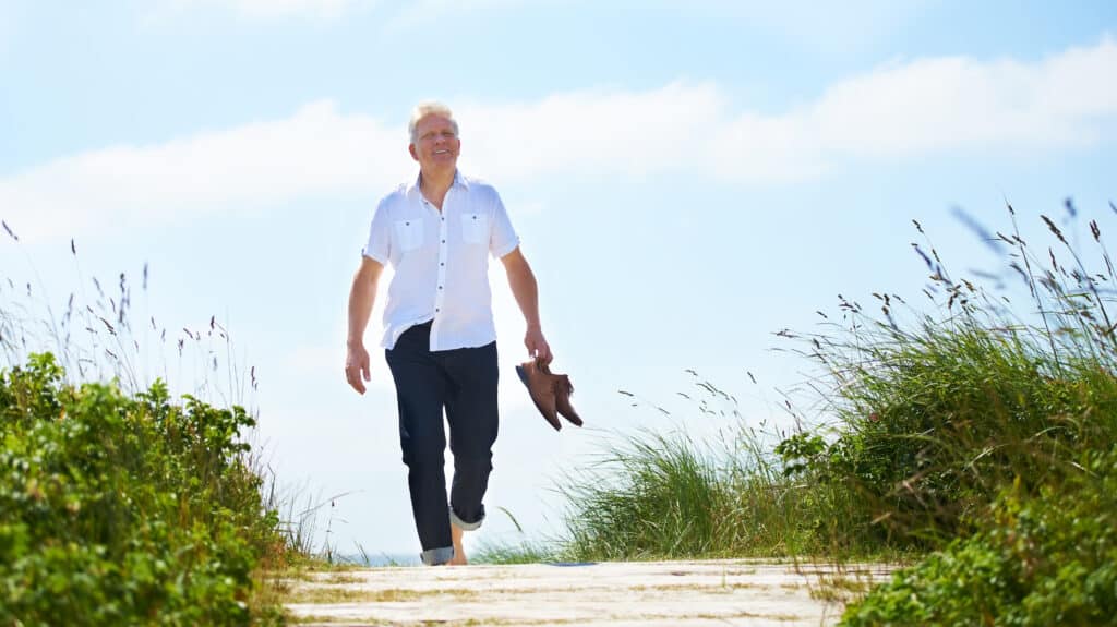 Image of a senior man walking barefoot without pain from gout.